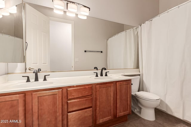 bathroom with double vanity, toilet, tile patterned floors, and a sink