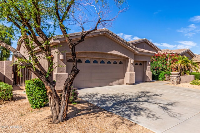 ranch-style home featuring driveway, a tile roof, a garage, fence, and stucco siding