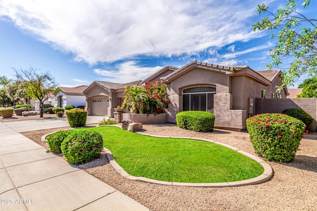 view of front facade featuring a front lawn, stucco siding, a tiled roof, an attached garage, and driveway