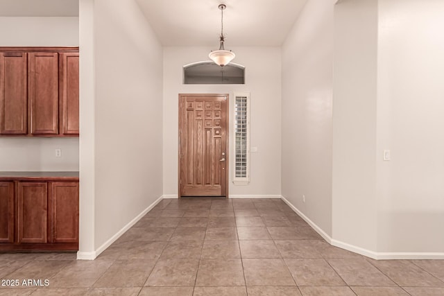 foyer entrance with baseboards and light tile patterned flooring