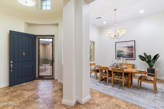 foyer with a high ceiling and a notable chandelier