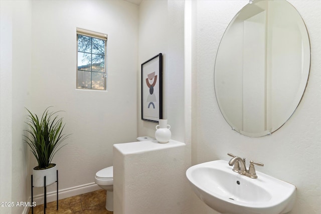 bathroom with sink and toilet