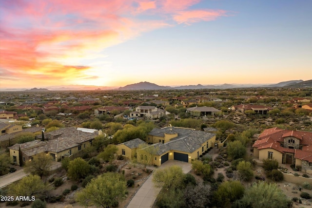 aerial view at dusk featuring a mountain view