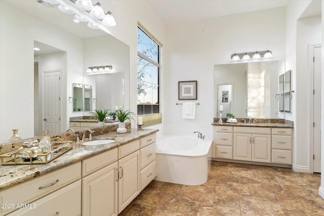 bathroom with vanity and a tub