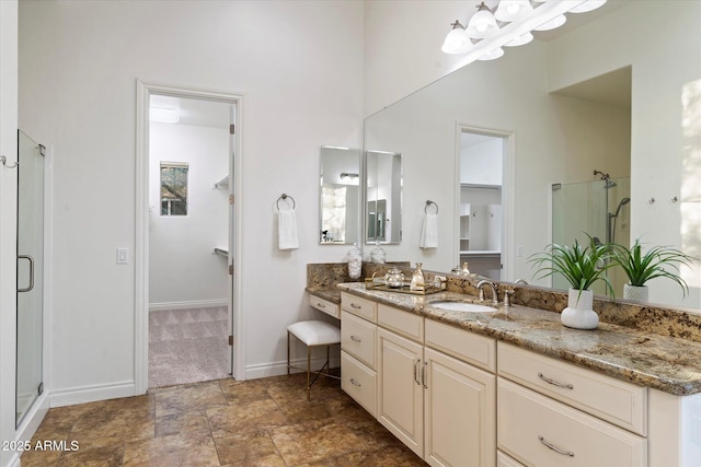 bathroom featuring vanity and a shower with door