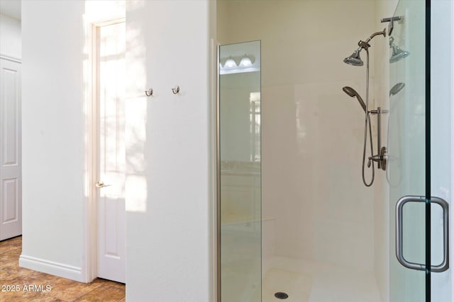 bathroom featuring a shower with door