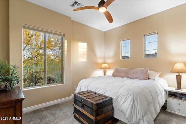 bedroom with ceiling fan, carpet flooring, and multiple windows