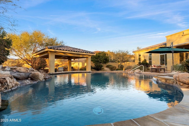 view of swimming pool with a gazebo, a patio area, and pool water feature