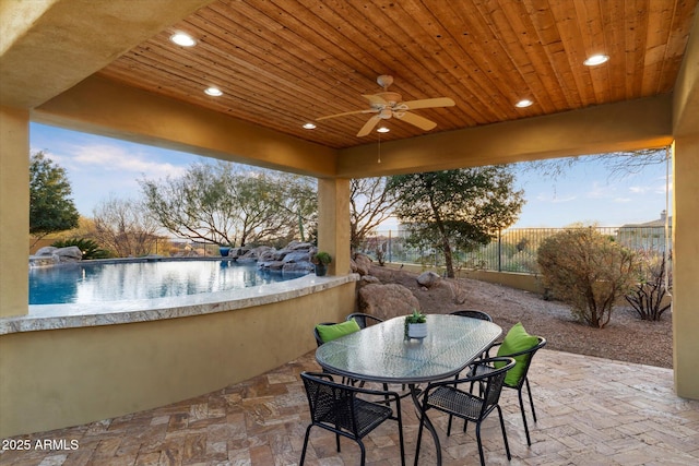 view of patio / terrace with an outdoor bar and ceiling fan