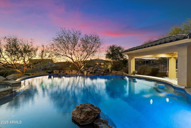 view of pool at dusk