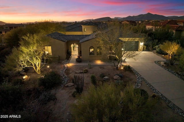 view of front of property featuring a garage and a mountain view