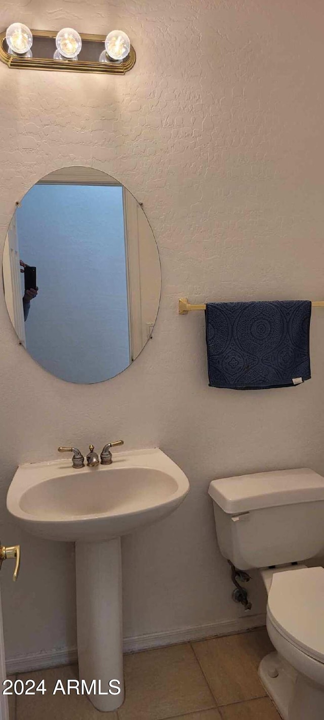 bathroom featuring tile patterned floors, toilet, and sink