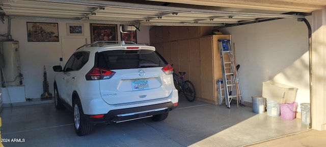 garage featuring wood walls and gas water heater