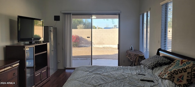 bedroom with access to exterior and dark wood-type flooring