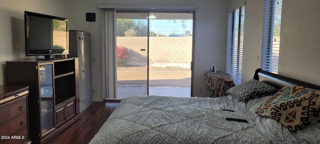 bedroom with access to outside and dark wood-type flooring