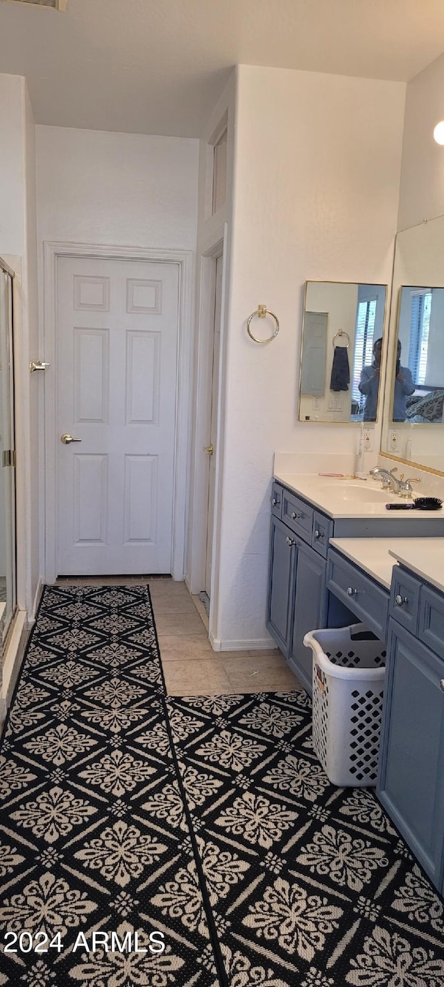 bathroom with vanity and a shower with door