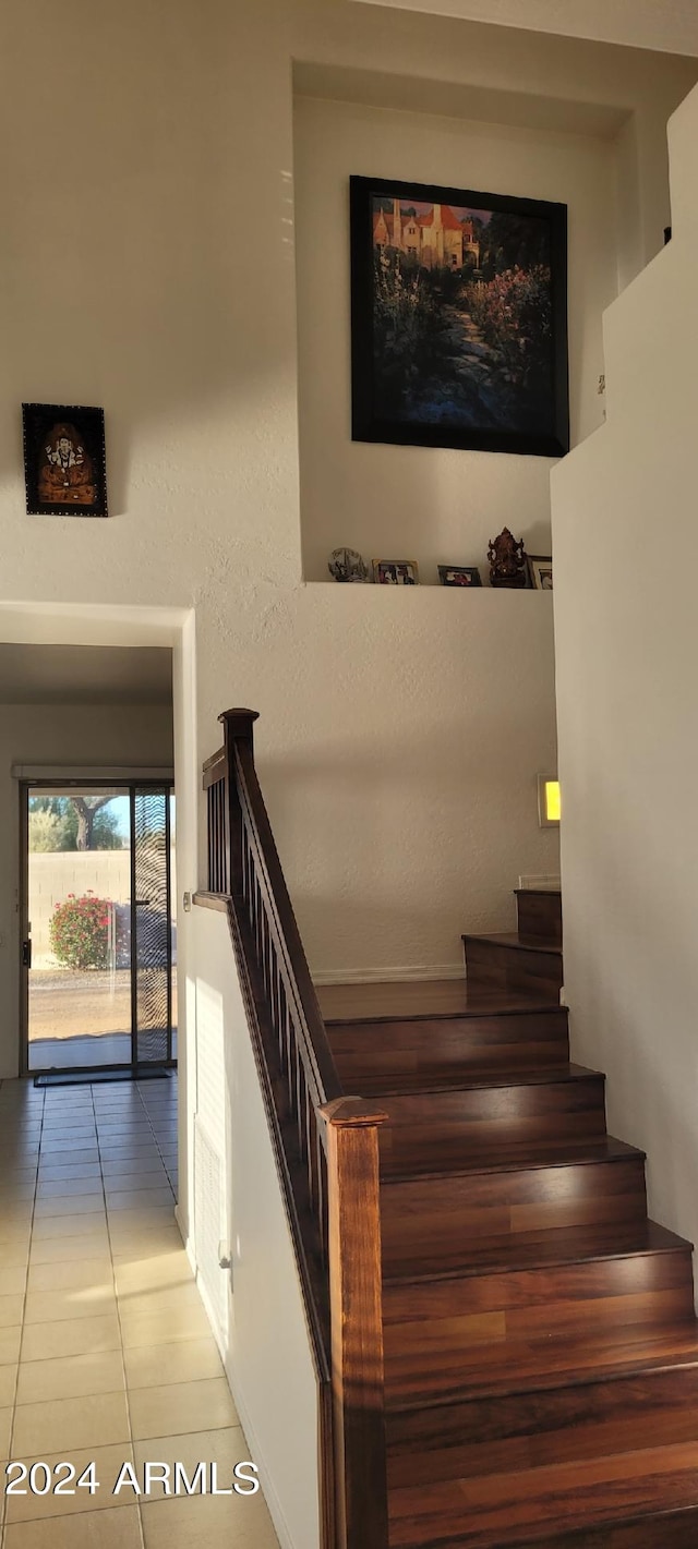 stairway with tile patterned floors