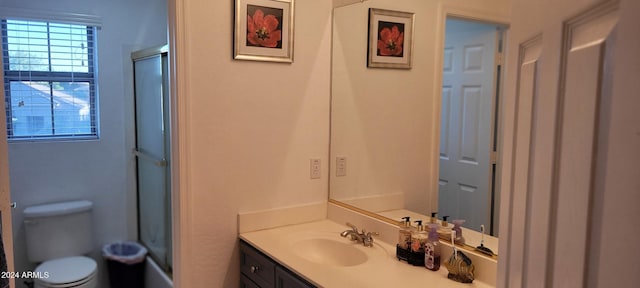 full bathroom featuring shower / bath combination with glass door, vanity, and toilet