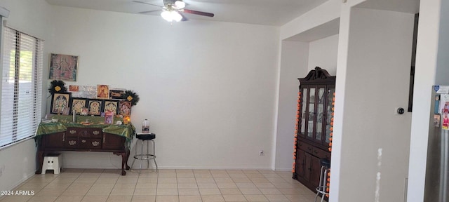 tiled foyer featuring ceiling fan