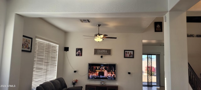 living room featuring ceiling fan and lofted ceiling