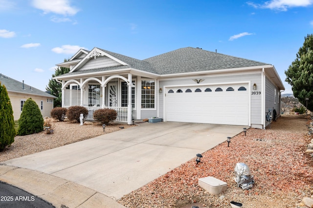 view of front of home featuring roof with shingles, covered porch, a garage, and concrete driveway