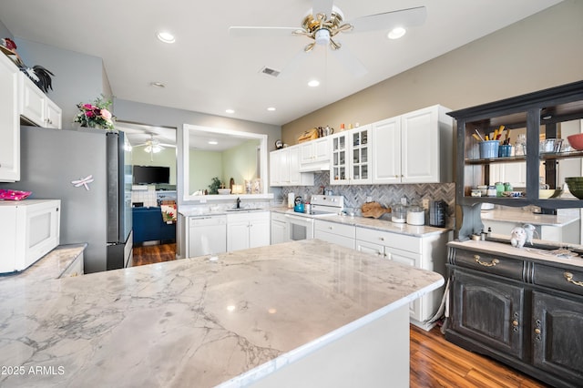 kitchen with glass insert cabinets, tasteful backsplash, a ceiling fan, and white appliances