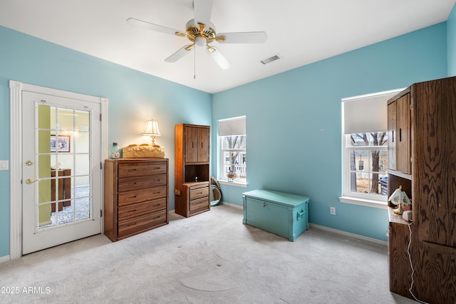 bedroom featuring baseboards, ceiling fan, visible vents, and light carpet