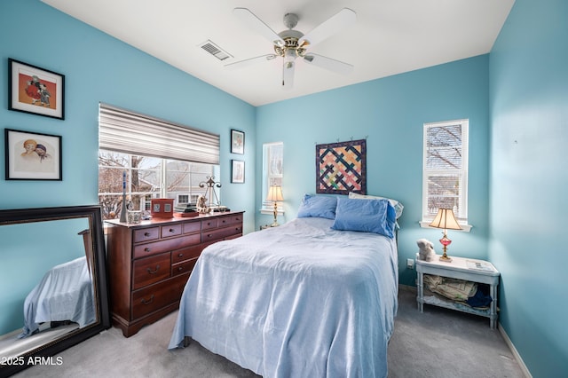 bedroom featuring light colored carpet, visible vents, ceiling fan, and baseboards