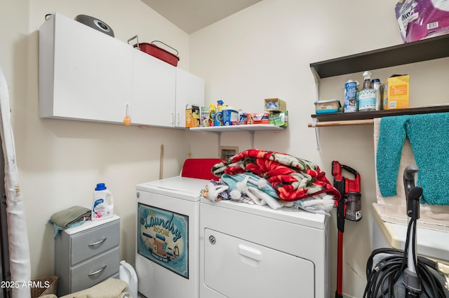 laundry area featuring washer and clothes dryer and cabinet space