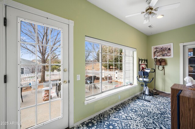entryway featuring visible vents, carpet, baseboards, and ceiling fan
