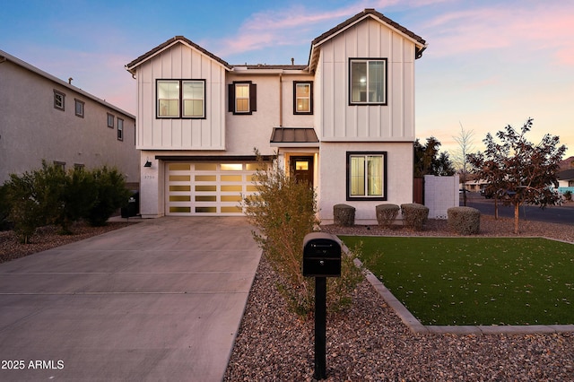 view of front facade featuring a garage and a lawn