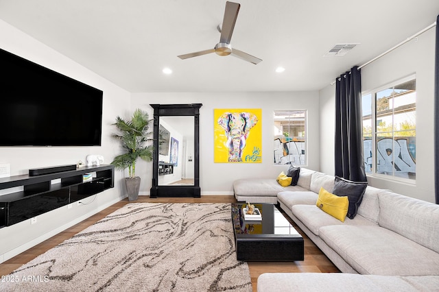 living room with ceiling fan and hardwood / wood-style floors