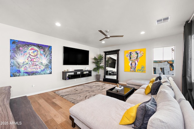 living room with ceiling fan and hardwood / wood-style floors