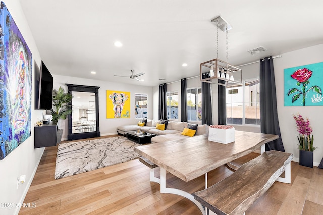 dining area featuring light hardwood / wood-style floors and ceiling fan