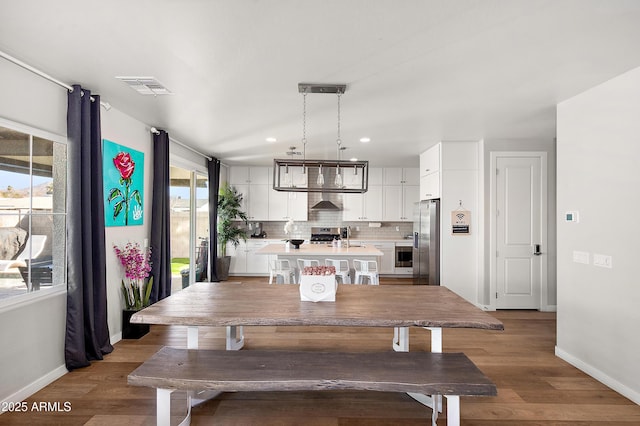 dining space with sink and hardwood / wood-style floors