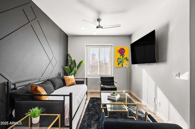 living room with ceiling fan and wood-type flooring