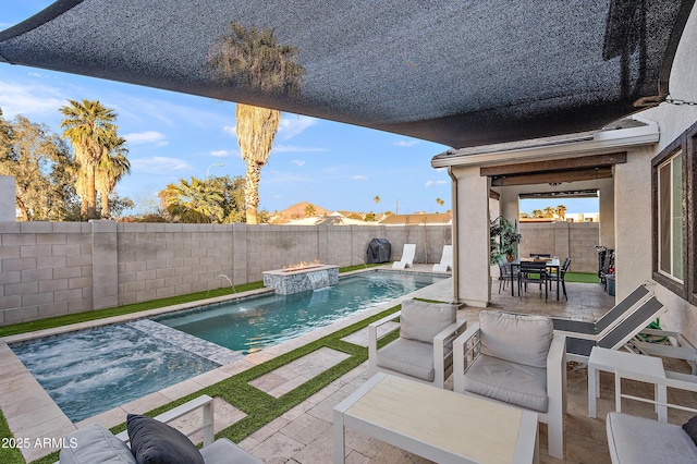 view of swimming pool featuring pool water feature and a patio