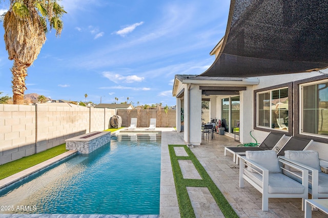 view of swimming pool featuring pool water feature, a patio area, and a jacuzzi