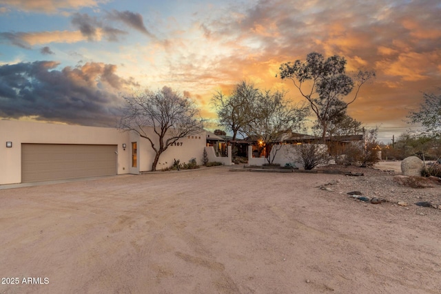 view of front of house featuring an attached garage and stucco siding