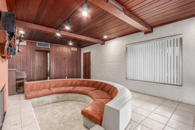 sunken living room featuring light tile patterned floors, wooden ceiling, visible vents, beam ceiling, and track lighting