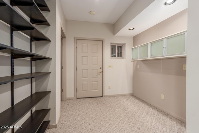 interior space featuring light carpet, recessed lighting, and baseboards