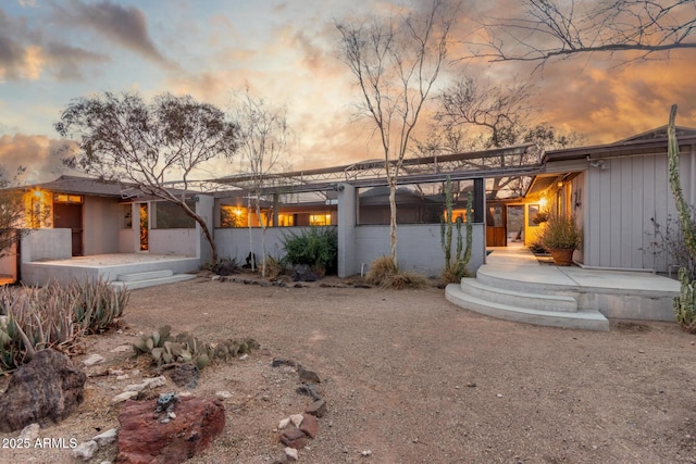 back of property with a patio