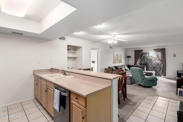 kitchen featuring dishwasher, sink, kitchen peninsula, and a textured ceiling