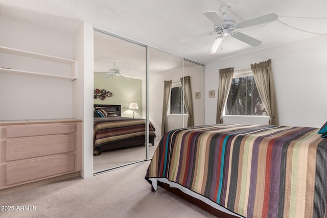 bedroom with light carpet, a closet, and ceiling fan