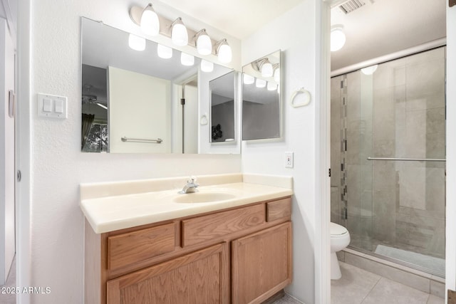 bathroom featuring tile patterned flooring, vanity, walk in shower, and toilet