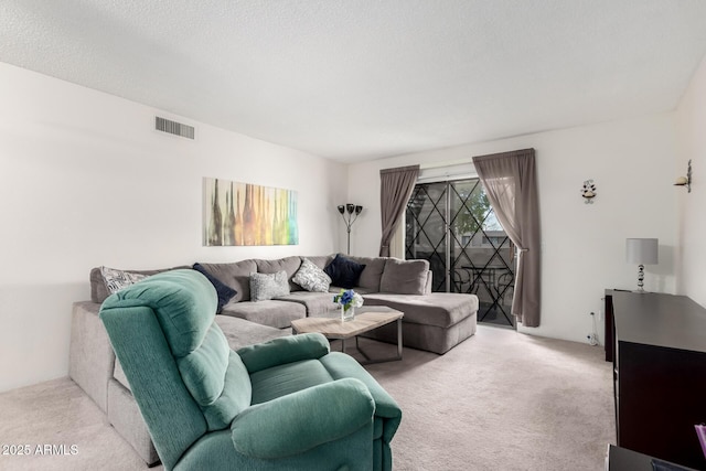 carpeted living room featuring a textured ceiling