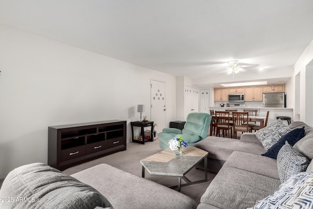 living room with ceiling fan and light colored carpet