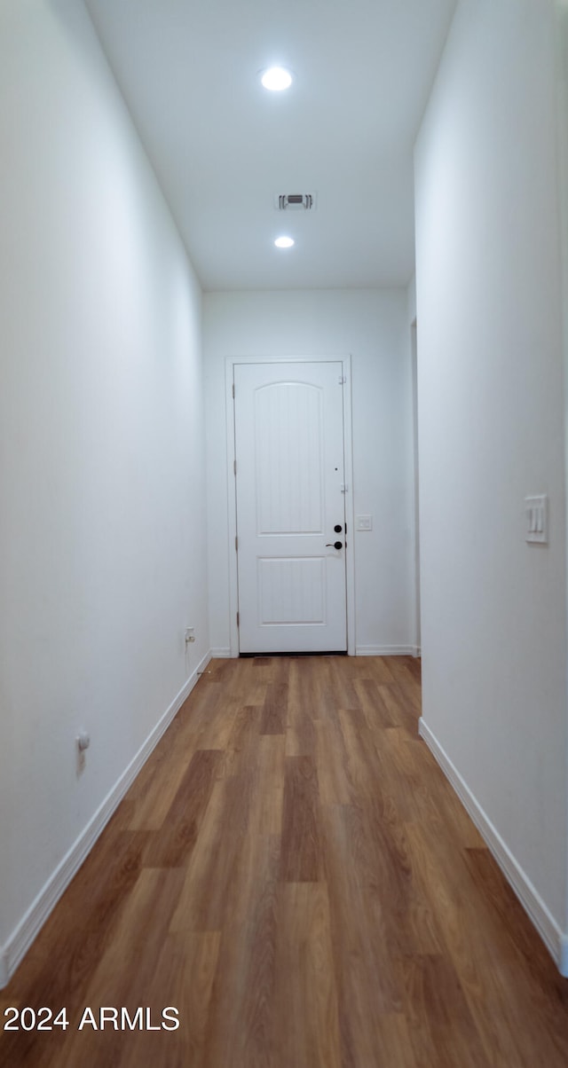 hallway featuring wood-type flooring