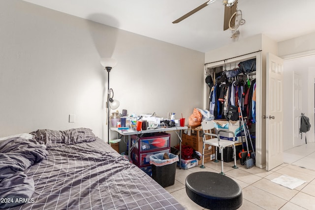 bedroom with a closet, ceiling fan, and light tile patterned floors