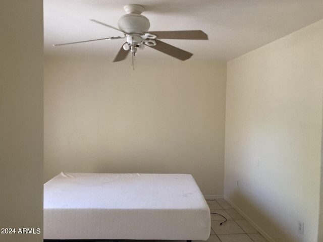 unfurnished bedroom with light tile patterned flooring and ceiling fan